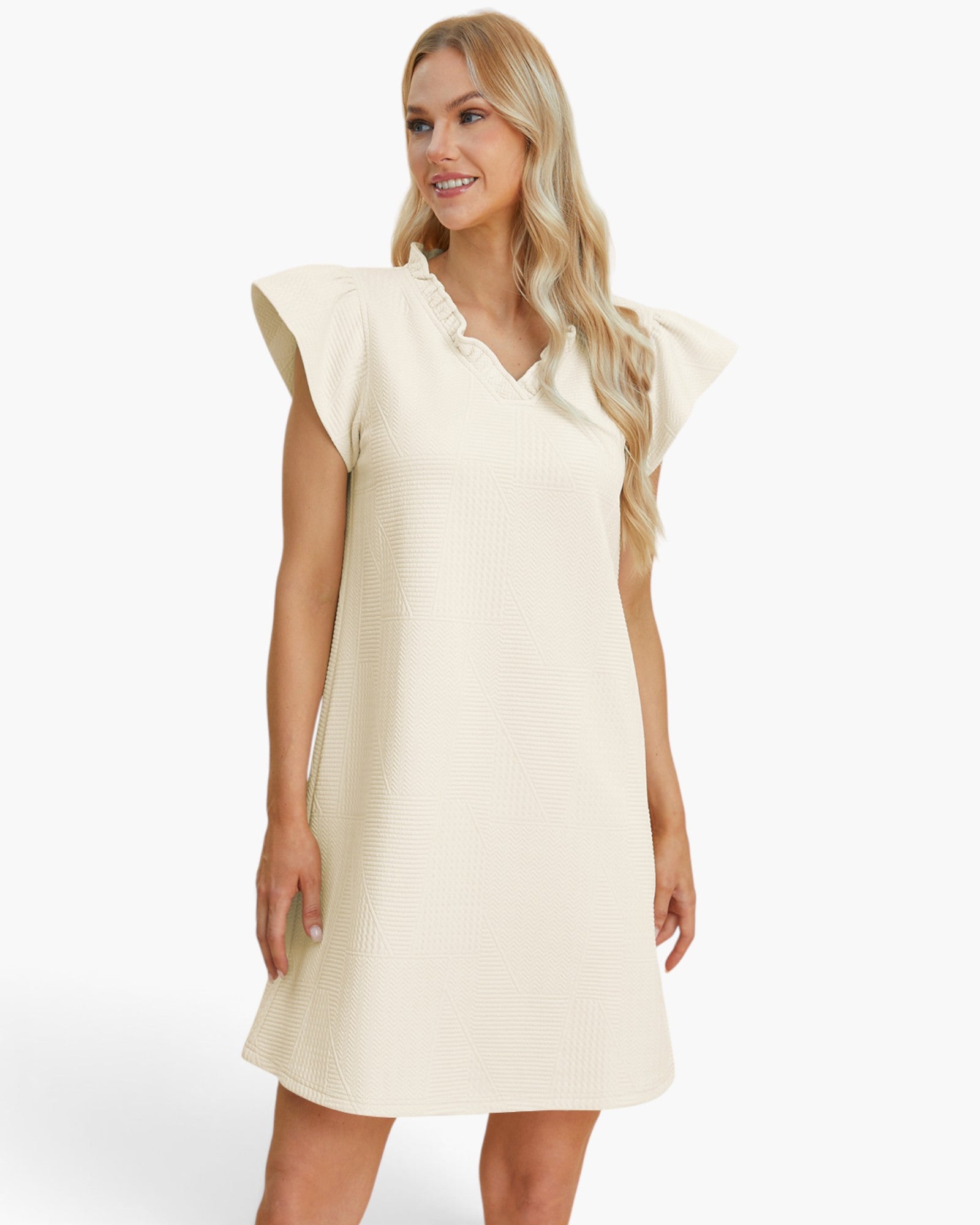 A woman modeling a cream-colored textured dress with ruffled cap sleeves and a V-neckline, set against a plain white studio background.