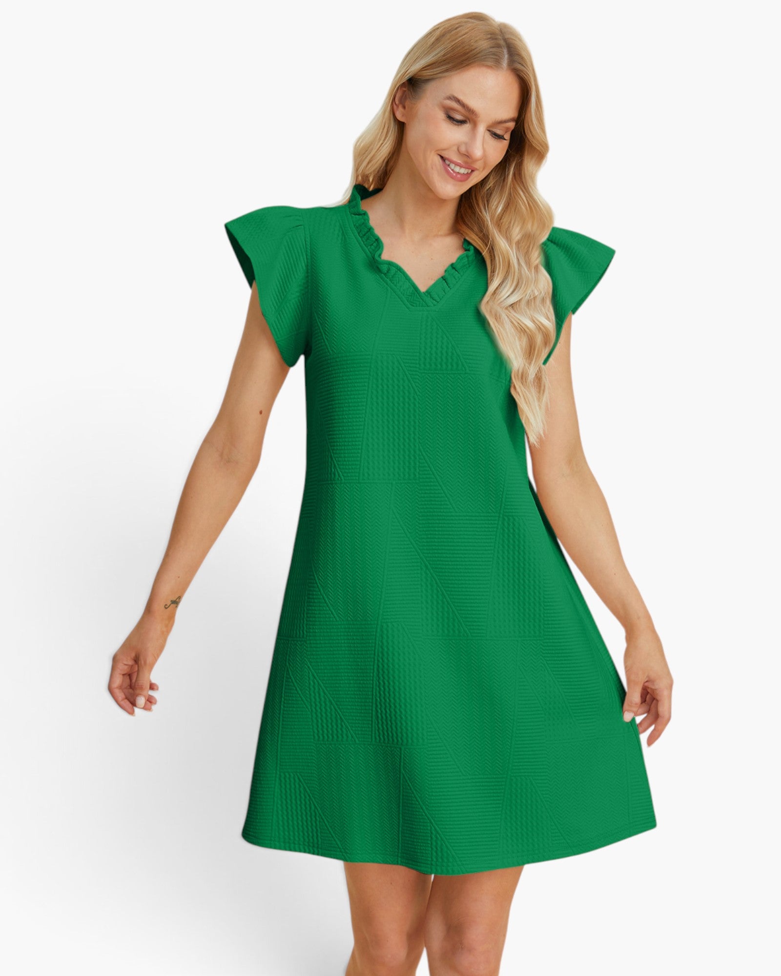 A woman modeling a bright green A-line mini dress with ruffled flutter sleeves and a ruffled V-neckline, set against a plain white studio background.