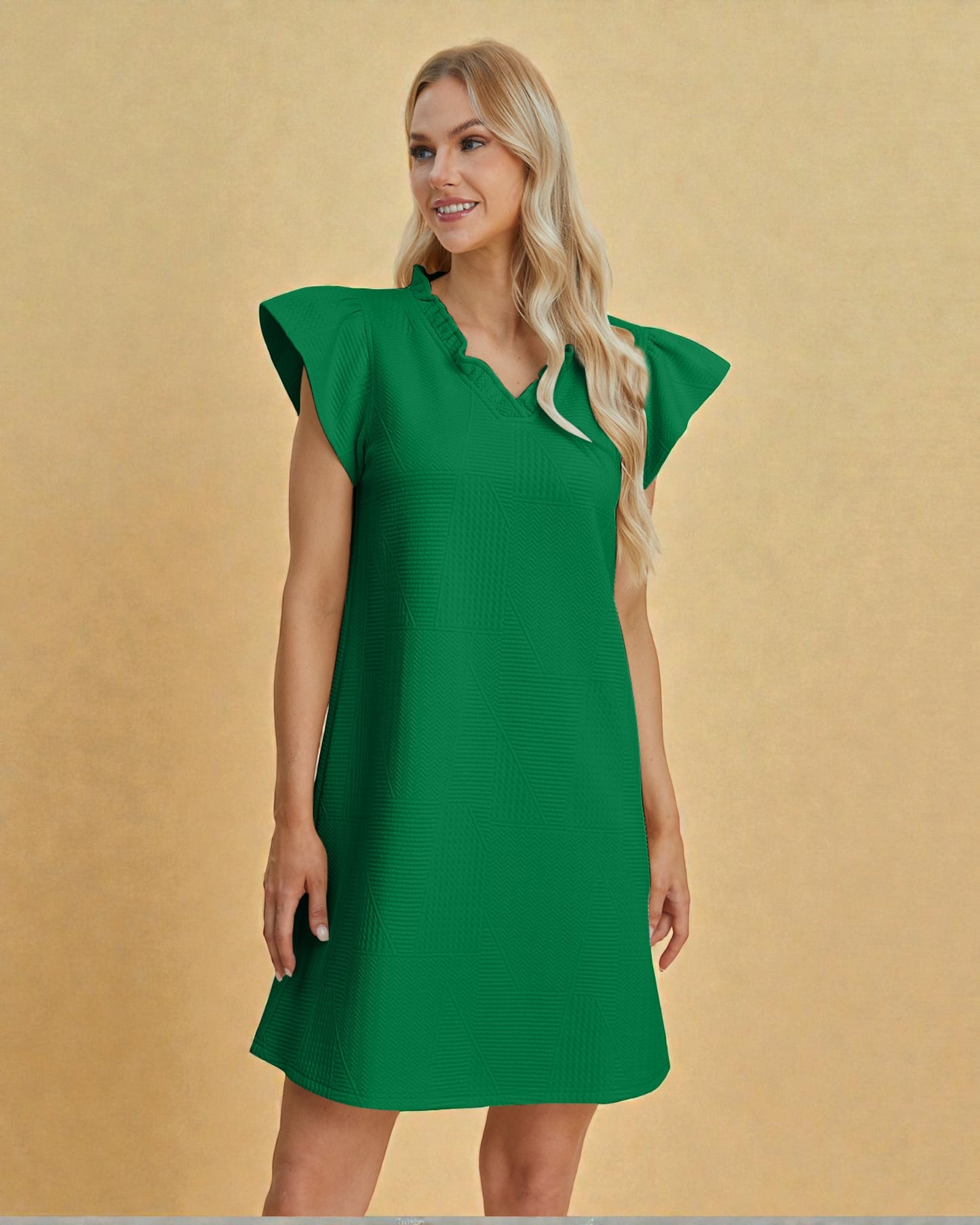 Woman wearing a green dress against a beige background