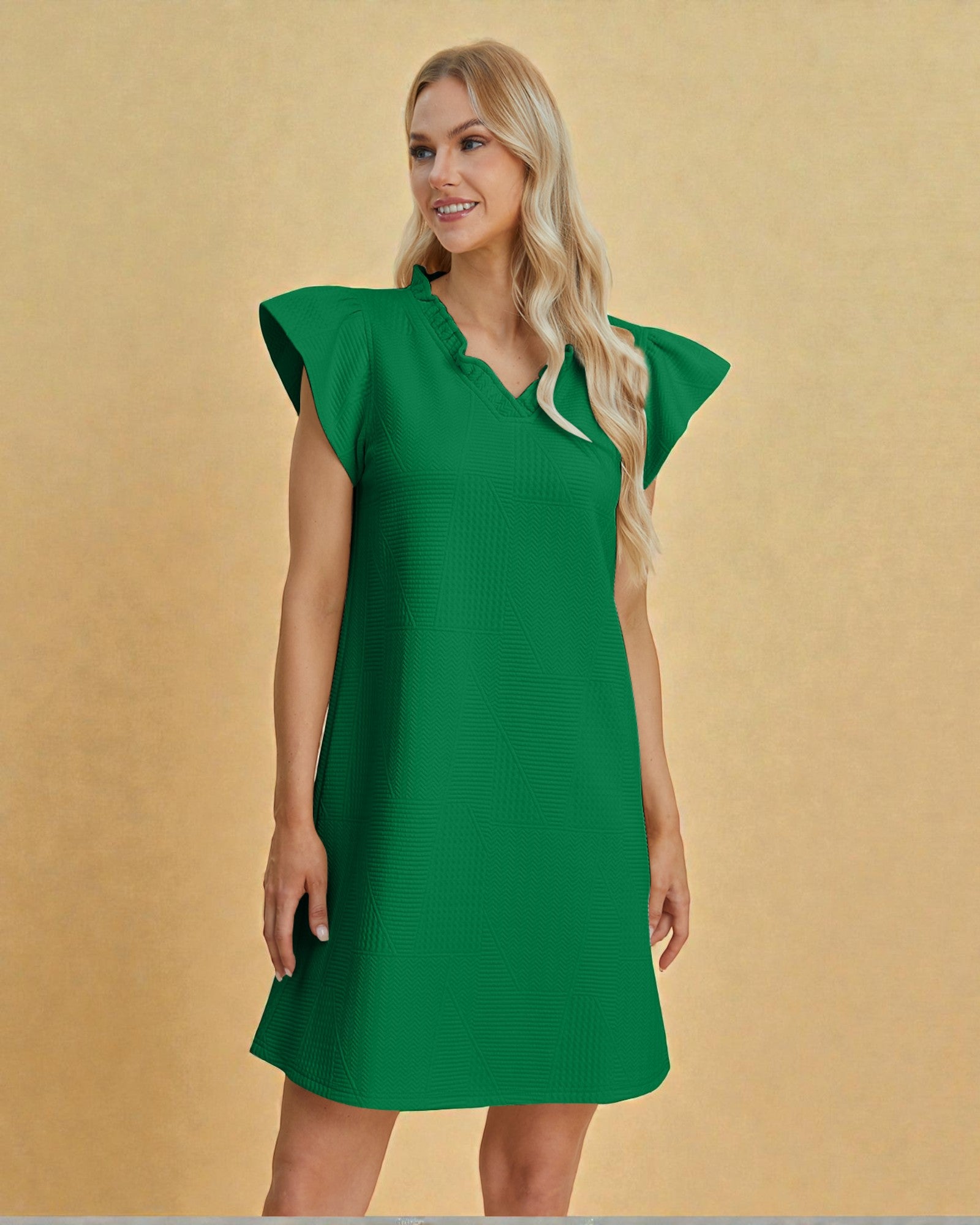 Woman wearing a green dress against a beige background