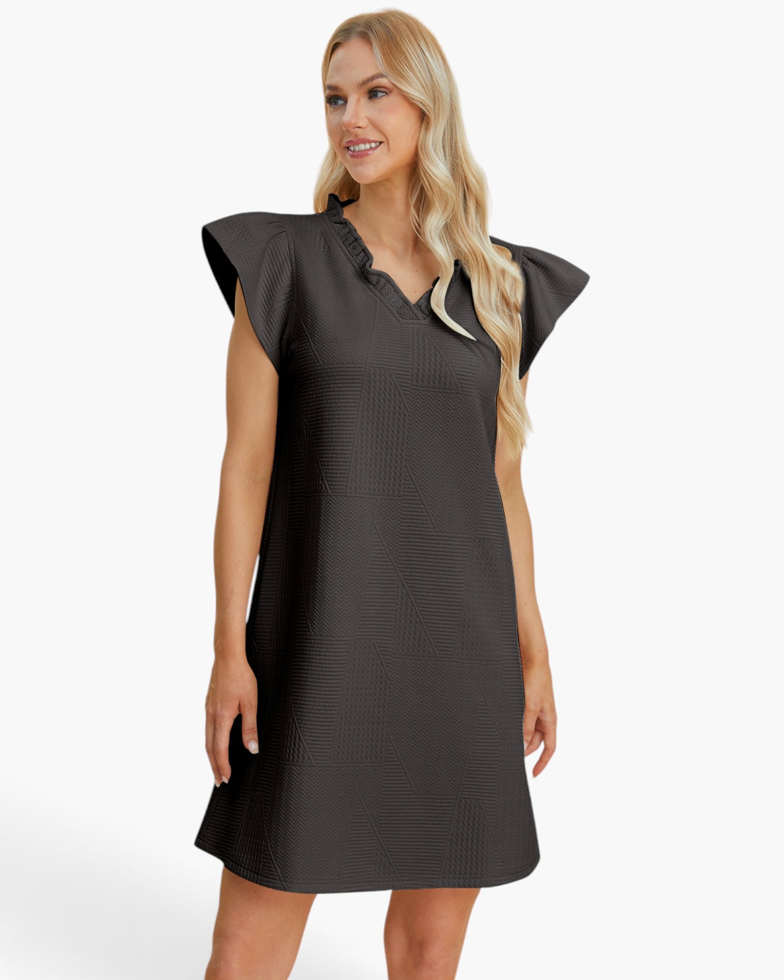A woman modeling a dark charcoal gray textured dress with ruffled cap sleeves and a split neckline, photographed against a clean white studio background.