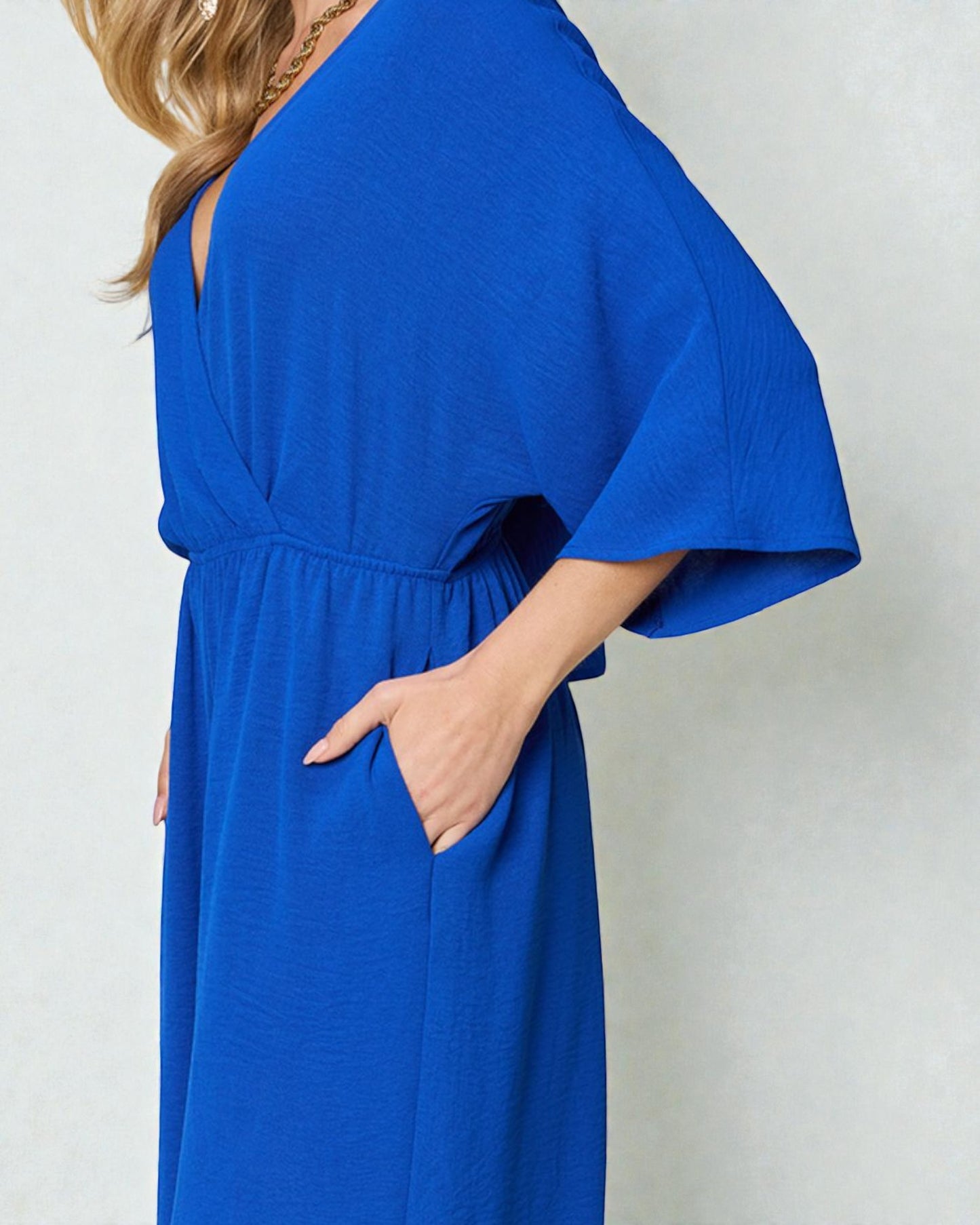 Blue dress worn by a person with a plain background