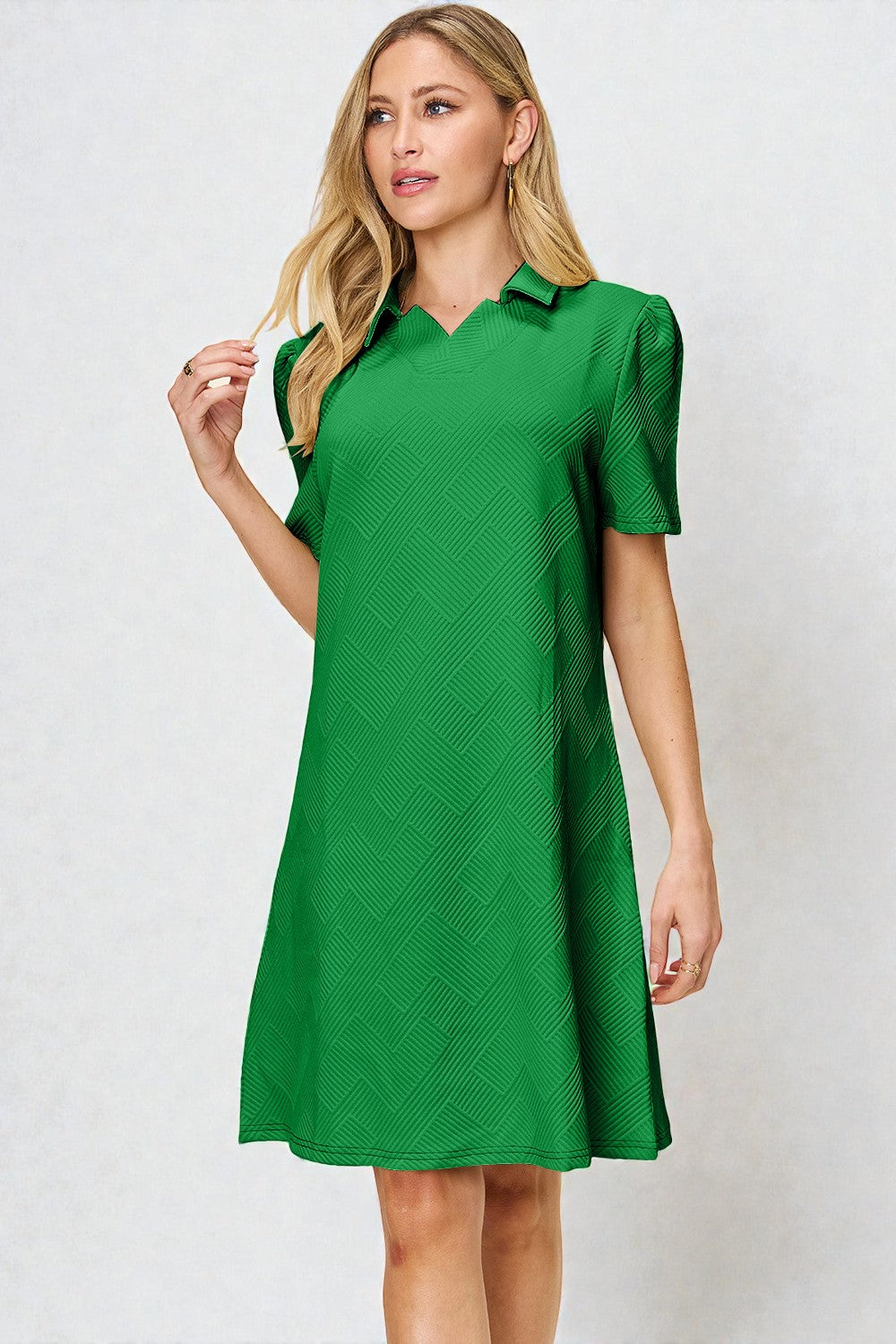Woman wearing a green dress against a white background