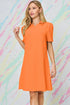 Woman wearing an orange dress against a colorful abstract background
