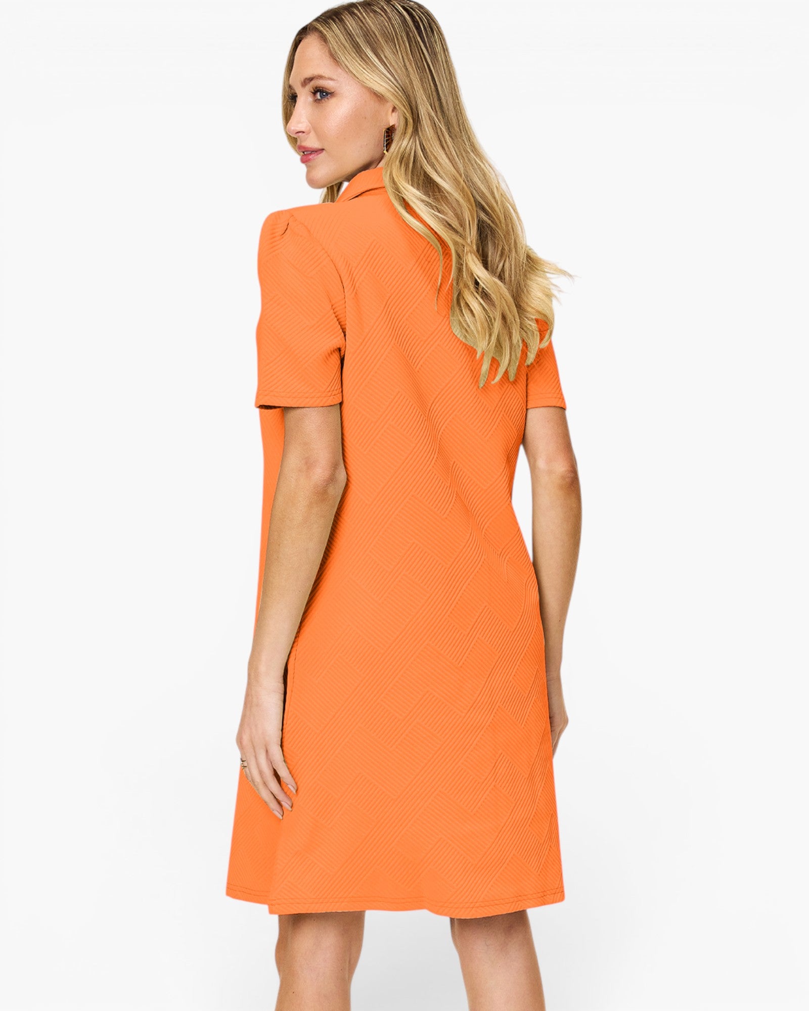 A woman modeling a bright orange short-sleeve dress from the back, shown against a plain white studio background.