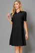 Woman wearing a black dress against a gray background
