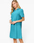 A woman modeling a short-sleeve collared shift dress in a bright turquoise blue color with a subtle textured pattern, set against a plain white studio background.