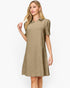 A woman modeling a short-sleeve collared shift dress in a warm khaki-beige color with a subtle textured chevron pattern, set against a plain white studio background.