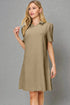 Woman wearing a beige dress with short sleeves against a gray background