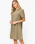 A woman modeling a short-sleeve collared shift dress in a muted taupe-brown color with a subtle textured pattern, set against a plain light gray studio background.