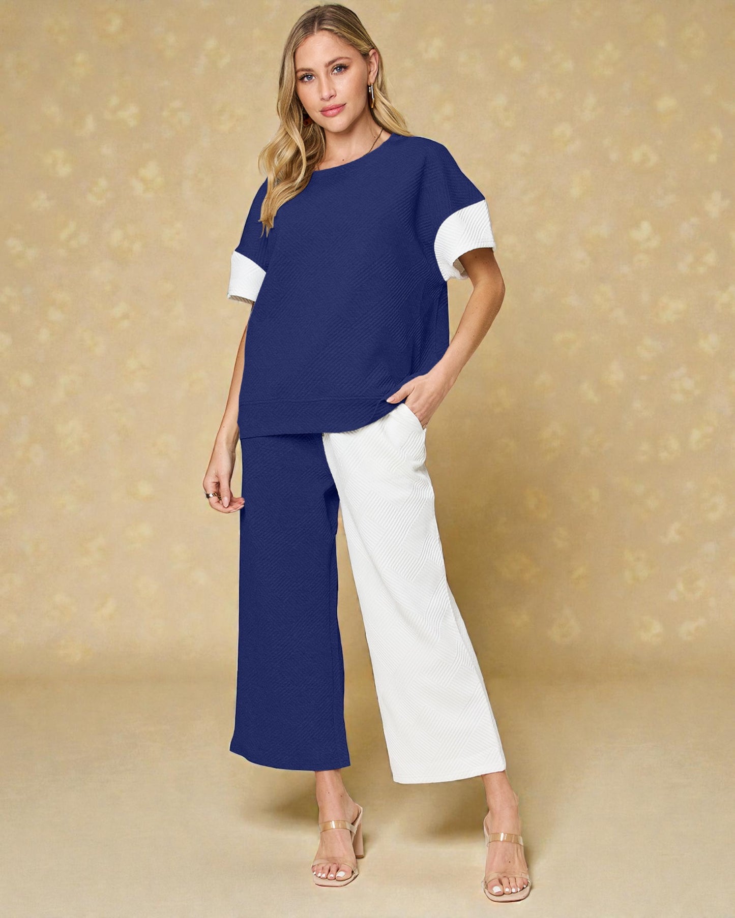 Woman wearing a blue and white outfit against a beige background