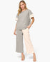 A woman modeling a two-piece color-blocked knit set featuring a short-sleeve top with gray and cream color blocking, and matching wide-leg cropped pants.