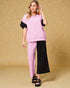 Woman wearing a pink and black outfit on a beige background