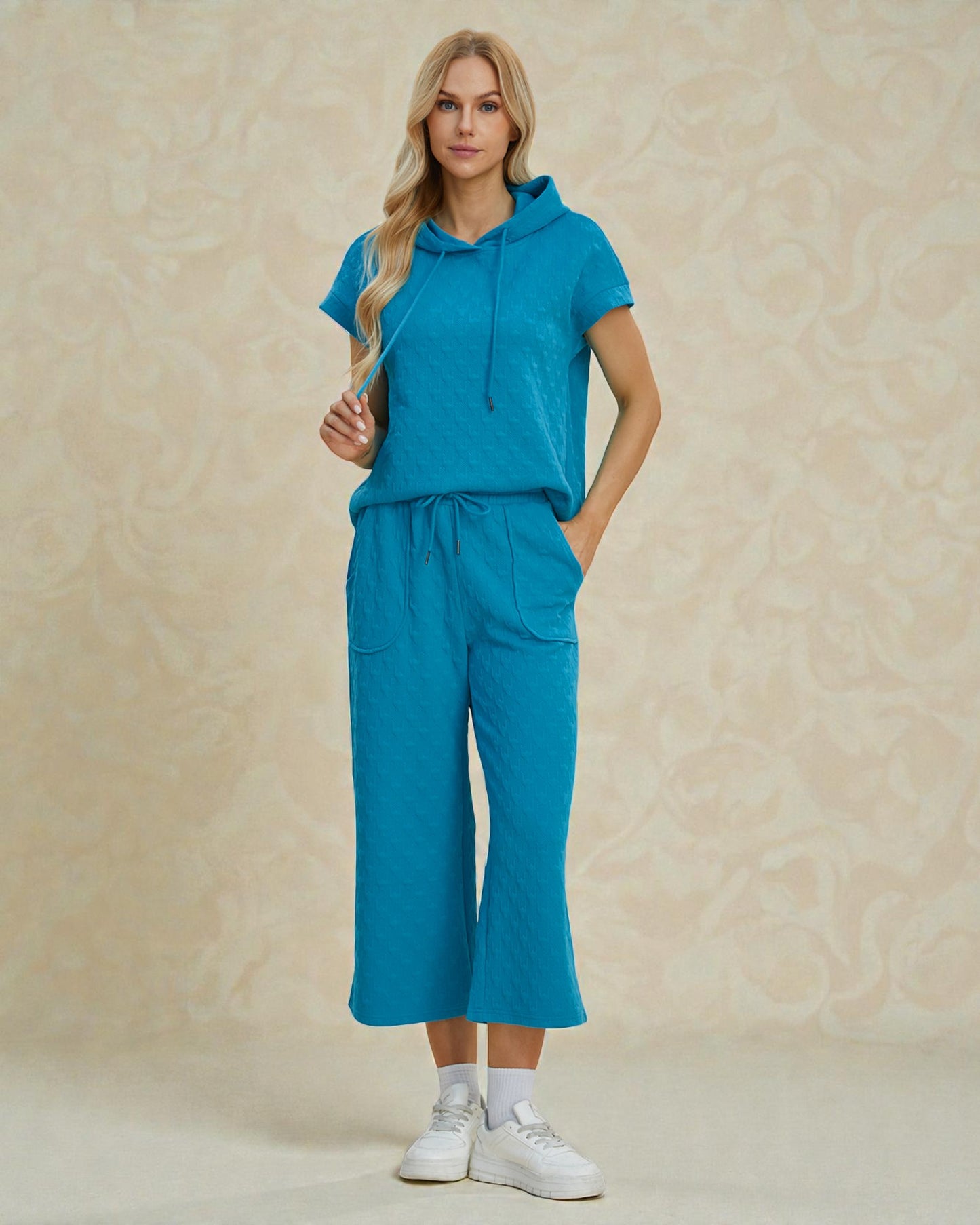 Woman wearing a blue outfit with a beige background