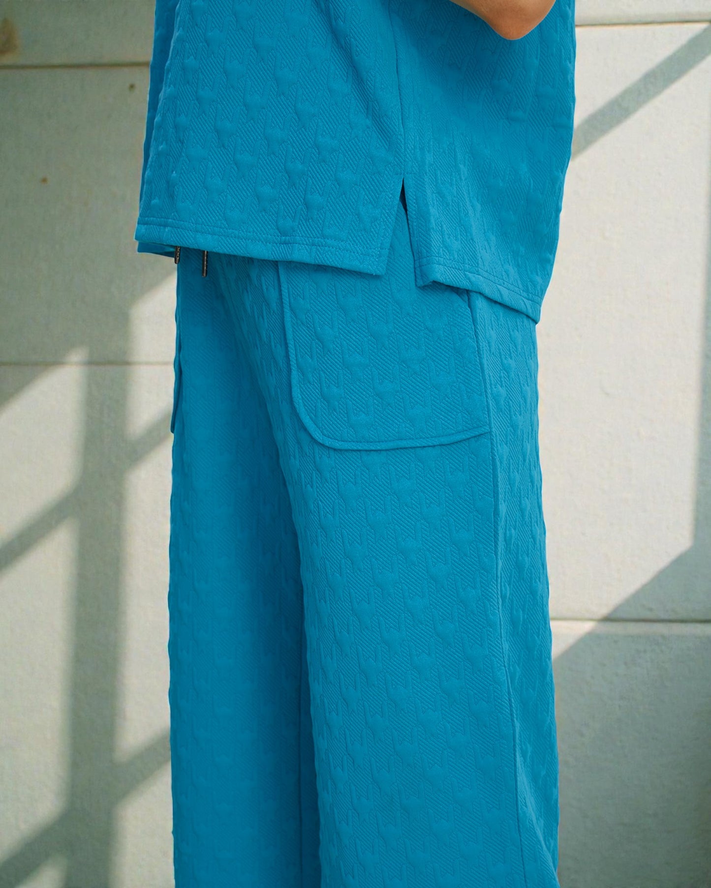 Person wearing a blue outfit against a light background