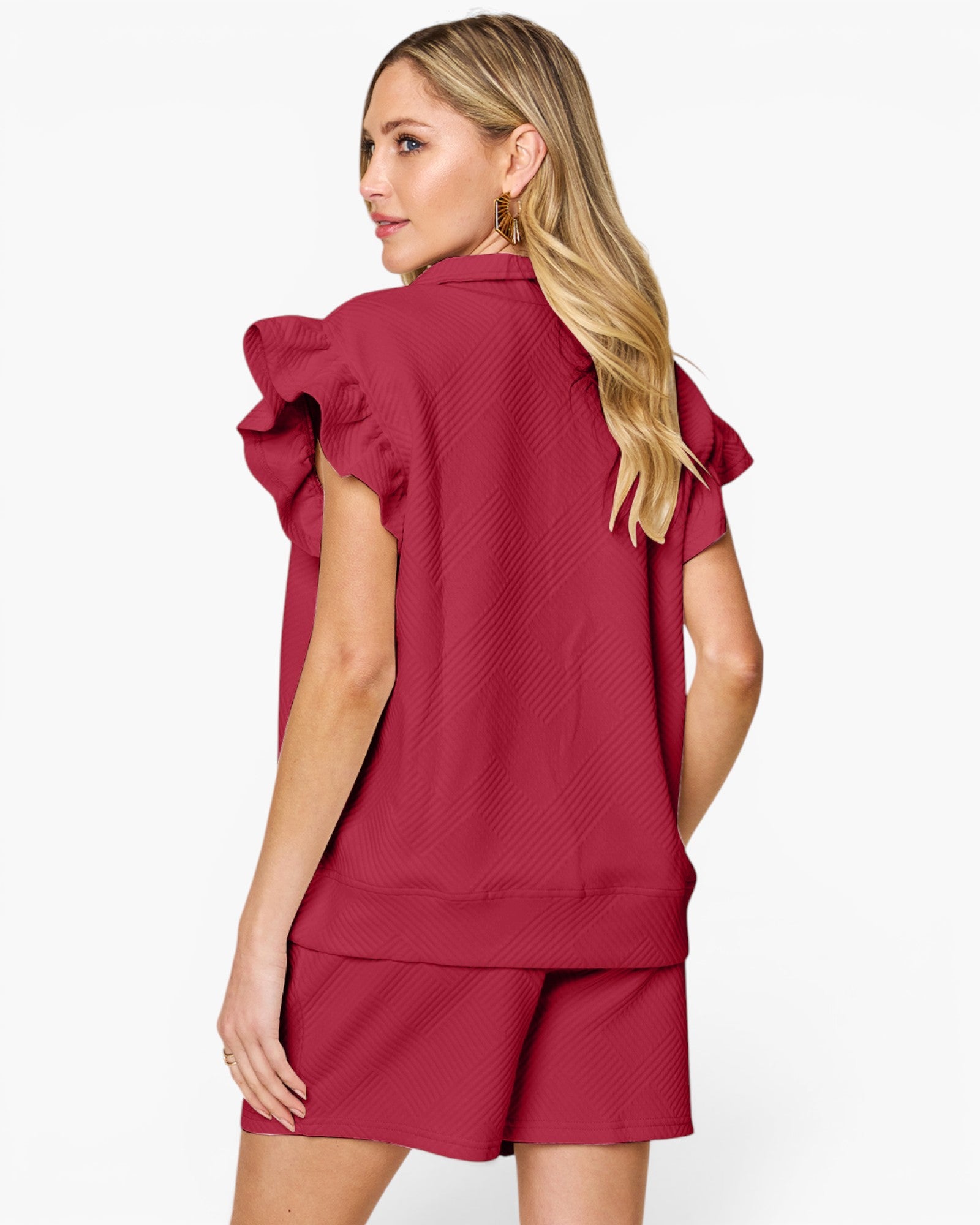A woman shown from the back wearing a matching burgundy two-piece set consisting of a short-sleeve top with dramatic ruffled shoulder details and matching shorts, against a plain white studio background.