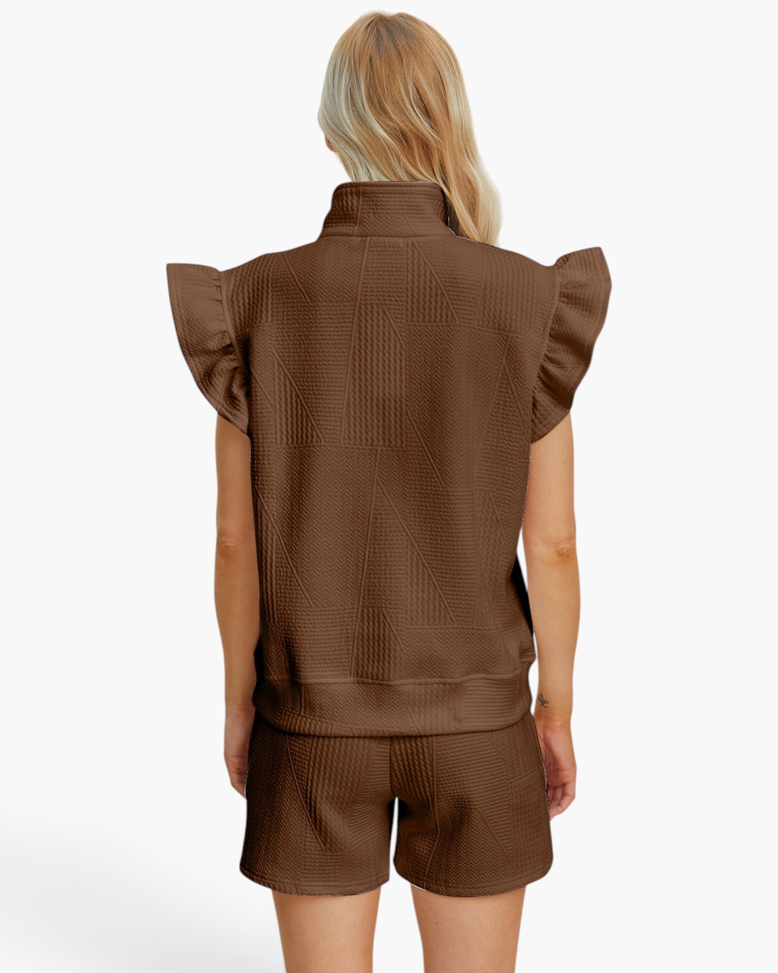 A woman shown from the back wearing a brown textured sleeveless top with ruffled shoulders and matching brown shorts against a plain white studio background.