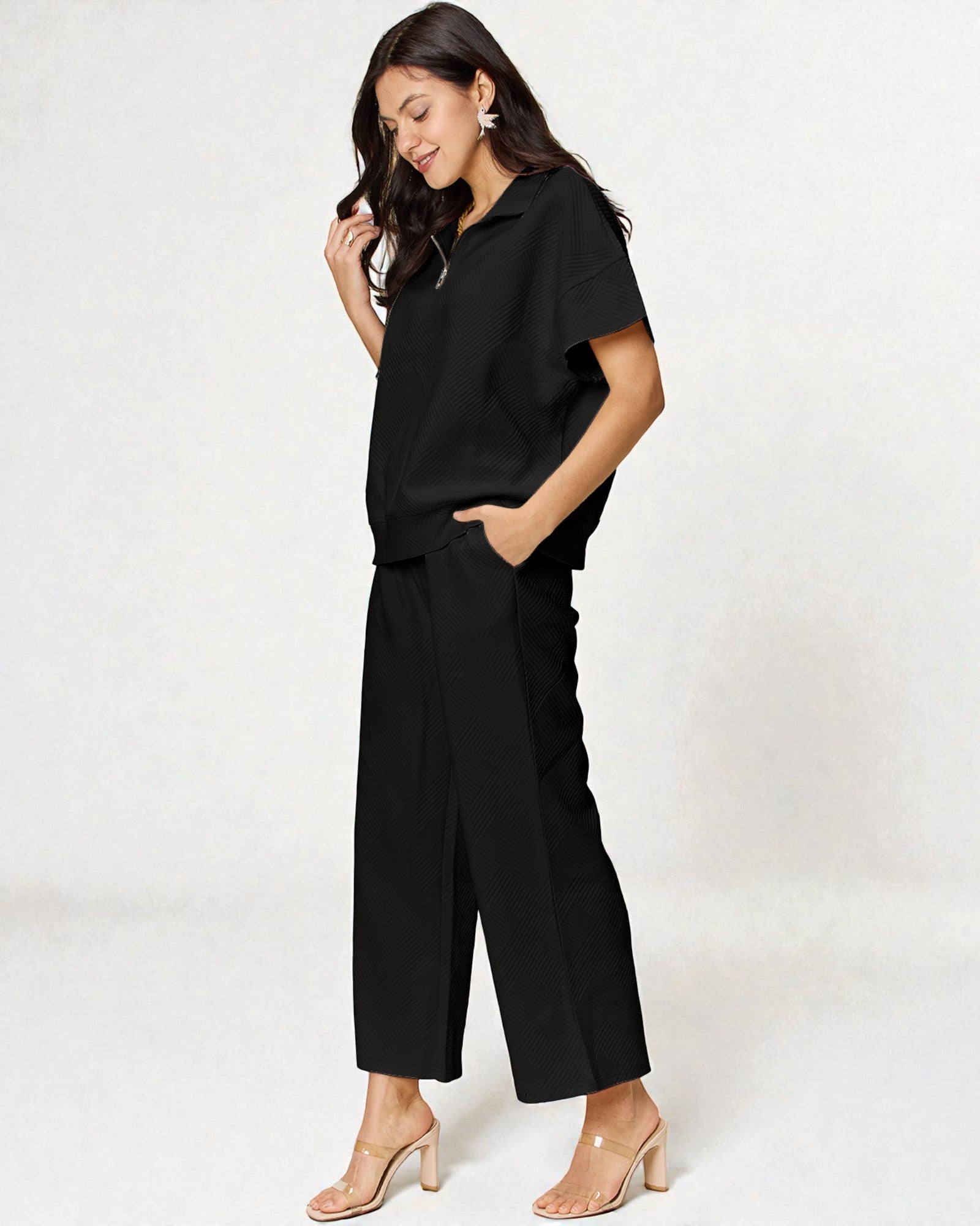 Woman wearing a black outfit on a white background