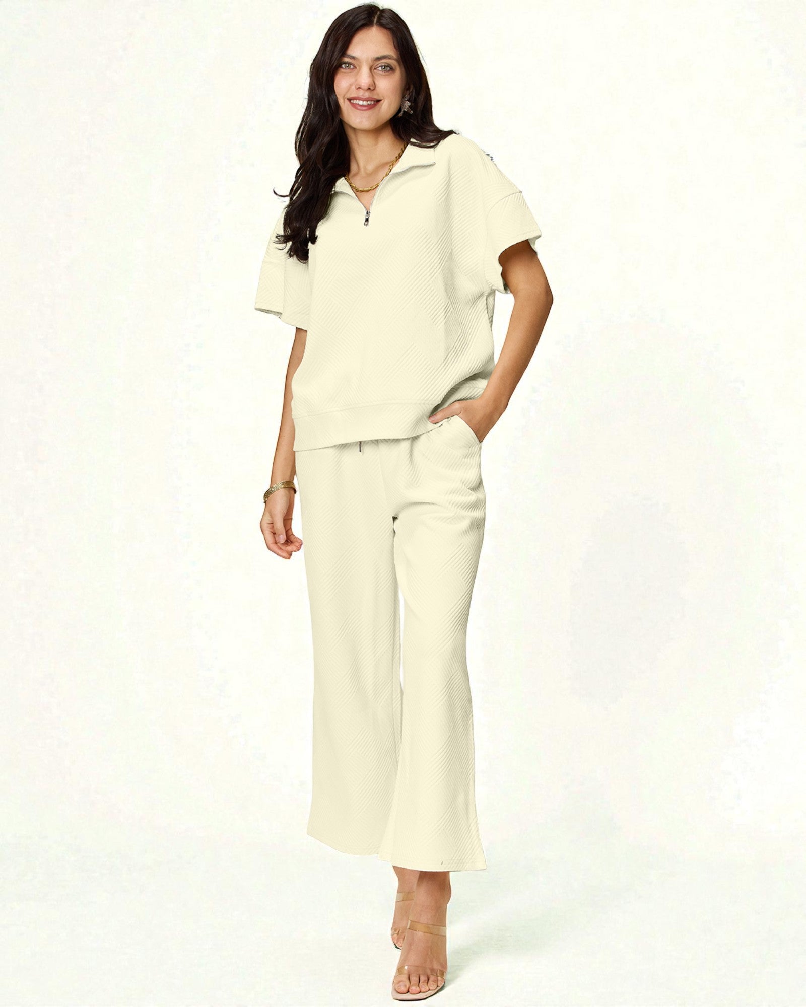 Woman wearing a cream-colored outfit on a white background