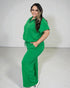 Woman wearing a green outfit on a white background