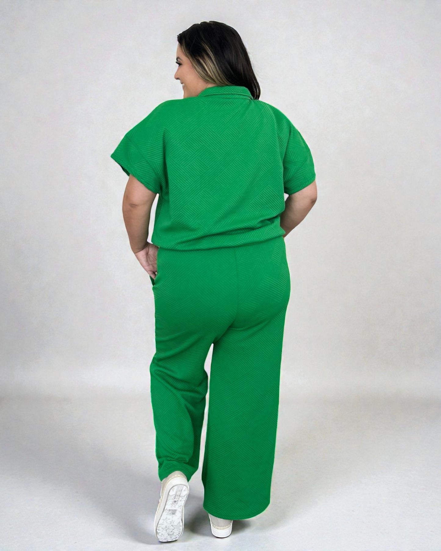 Person wearing a green jumpsuit on a white background