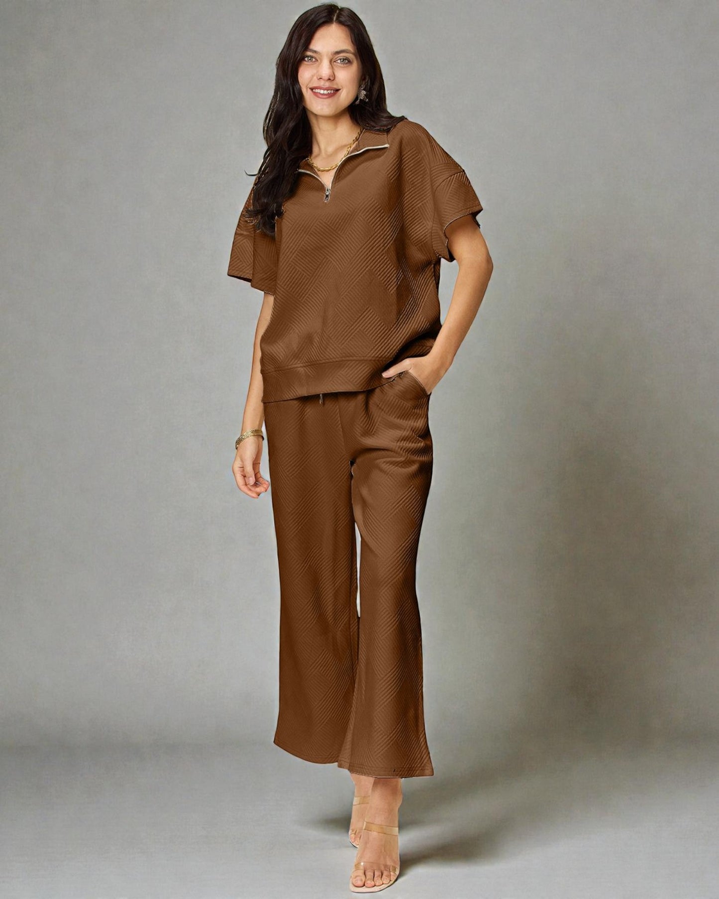 Woman wearing a brown outfit against a gray background