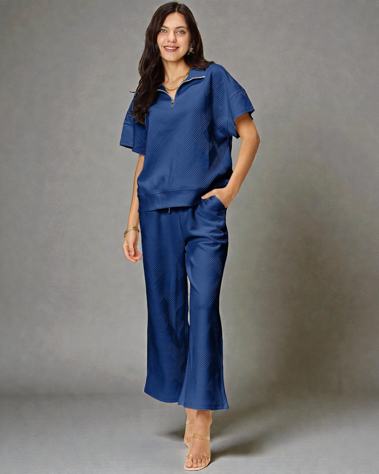 Woman wearing a blue outfit against a gray background