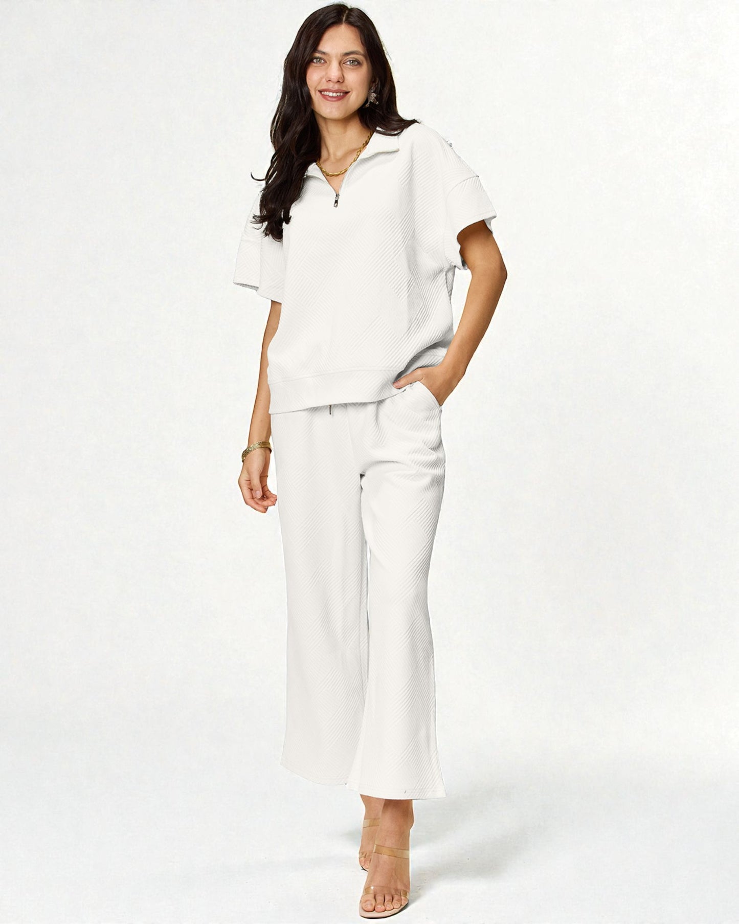 Woman wearing a white outfit on a plain background