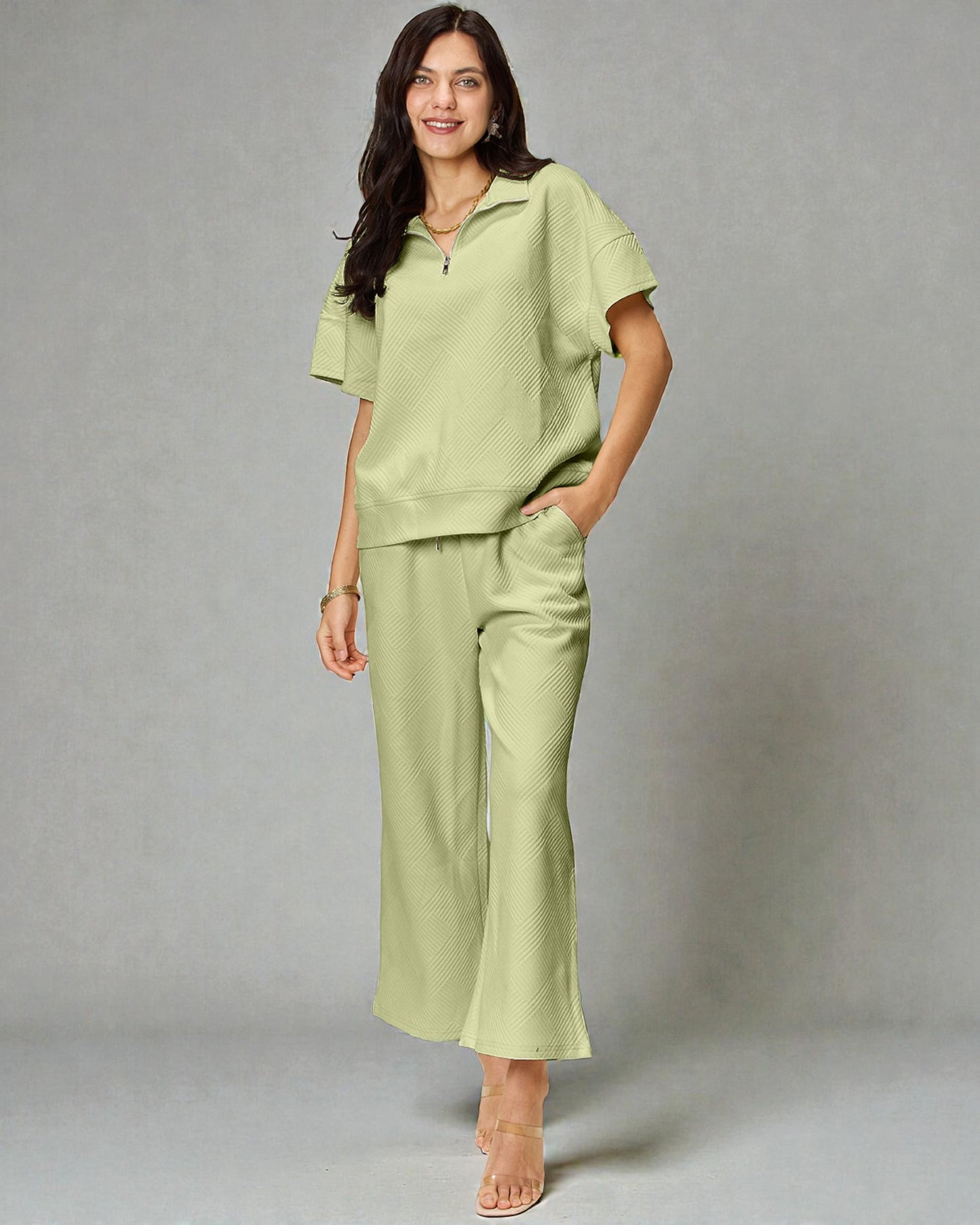 Woman wearing a light green outfit against a gray background