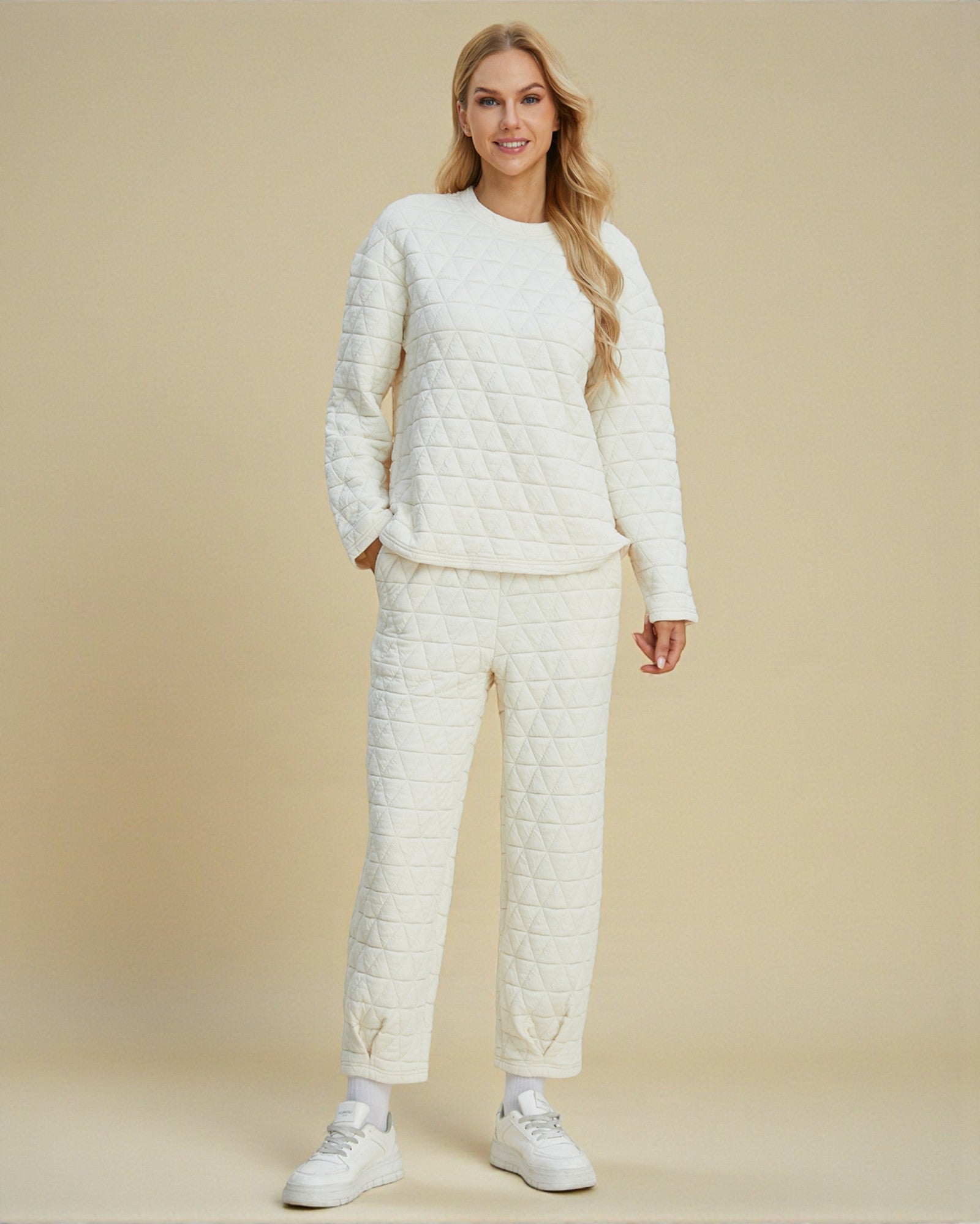 Woman wearing a white quilted outfit on a beige background