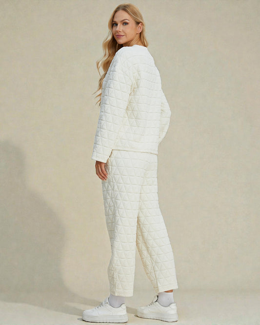 Woman wearing a white quilted outfit against a beige background