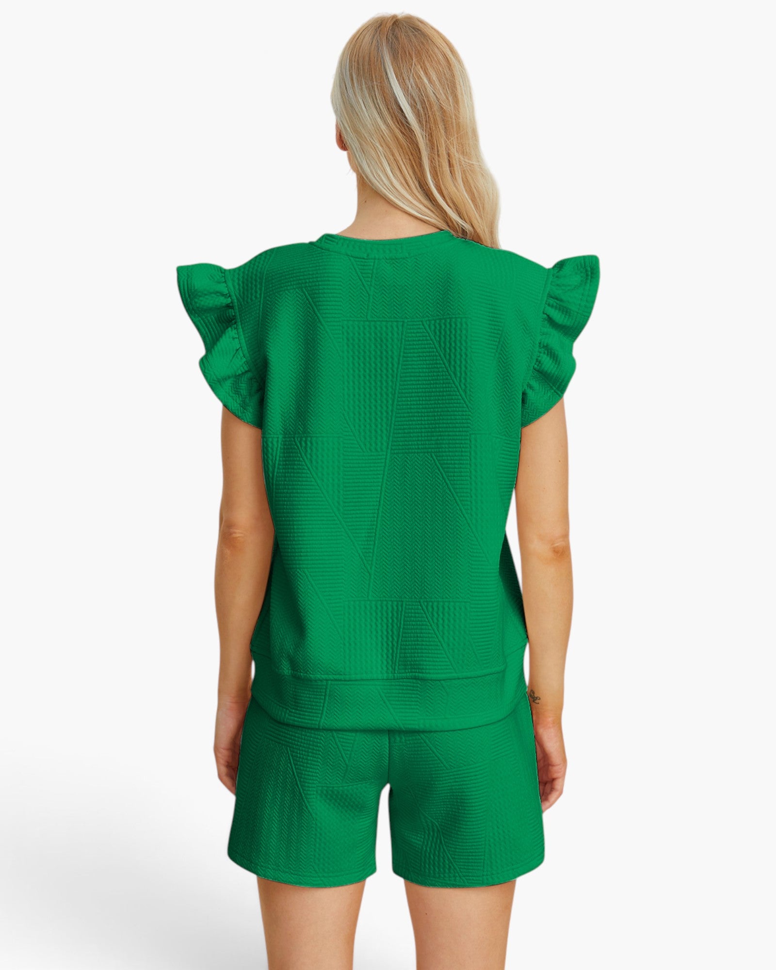 A woman shown from the back wearing a bright green textured knit matching set with ruffled short sleeves and shorts, against a plain white studio background.