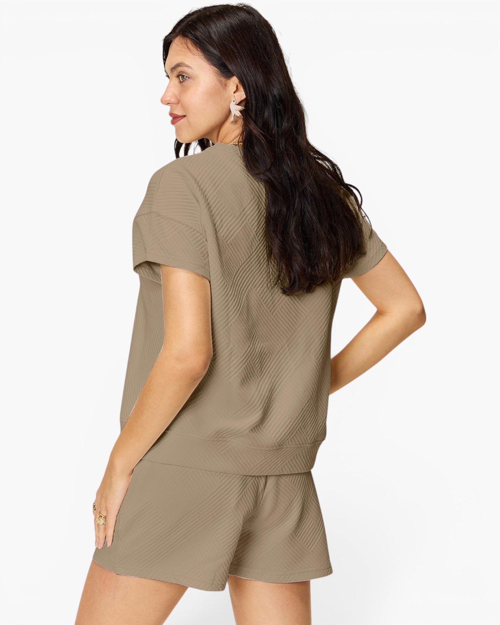 A woman wearing a matching taupe short-sleeve top and shorts set, shown from a three-quarters back view against a plain white background.
