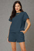 Woman wearing a blue outfit against a gray background