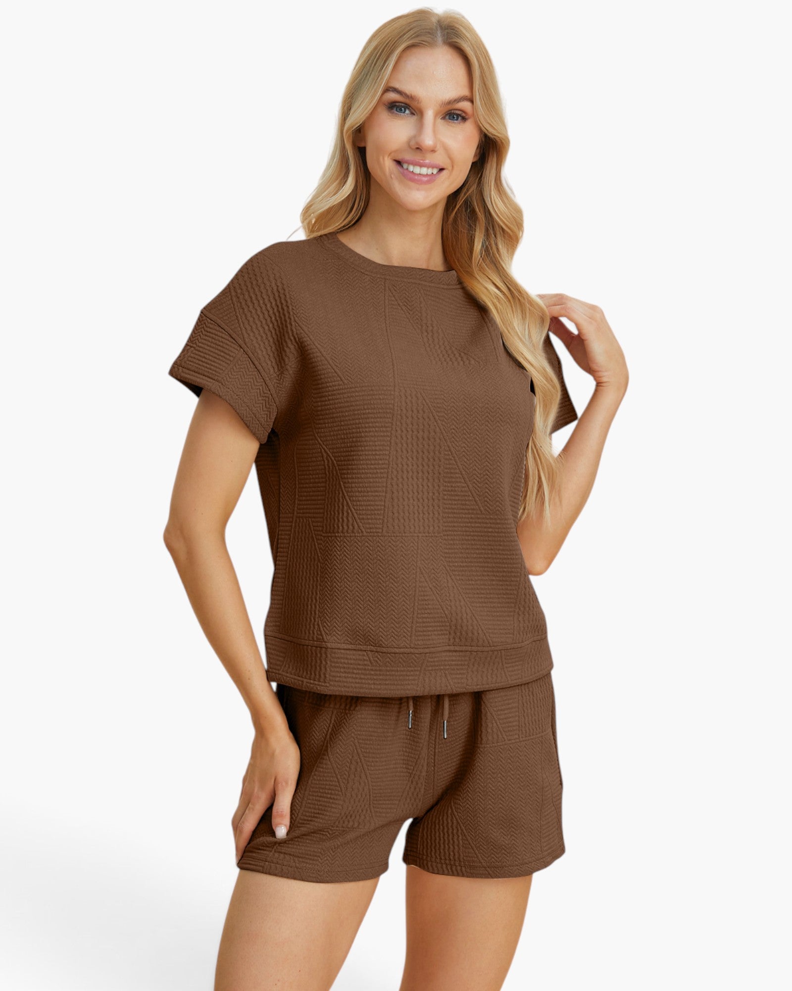 A woman modeling a matching brown short-sleeve top and shorts set with a textured waffle-weave pattern, photographed against a clean white background.