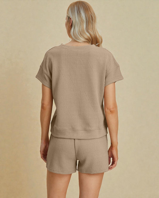 Person wearing a beige knit outfit on a beige background