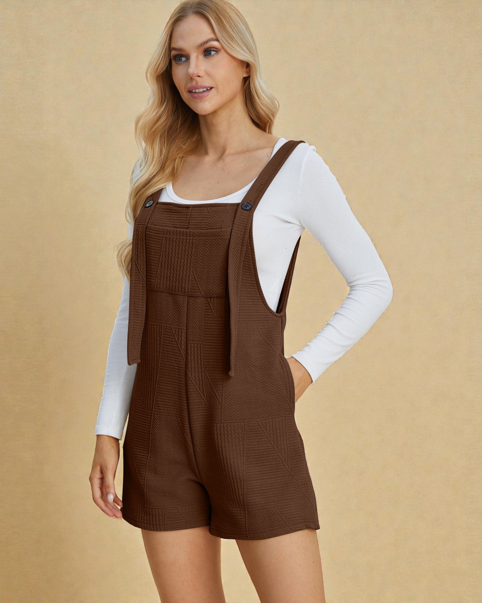 Woman wearing a brown ribbed knit romper with a beige background