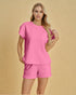Woman wearing a pink textured outfit on a beige background