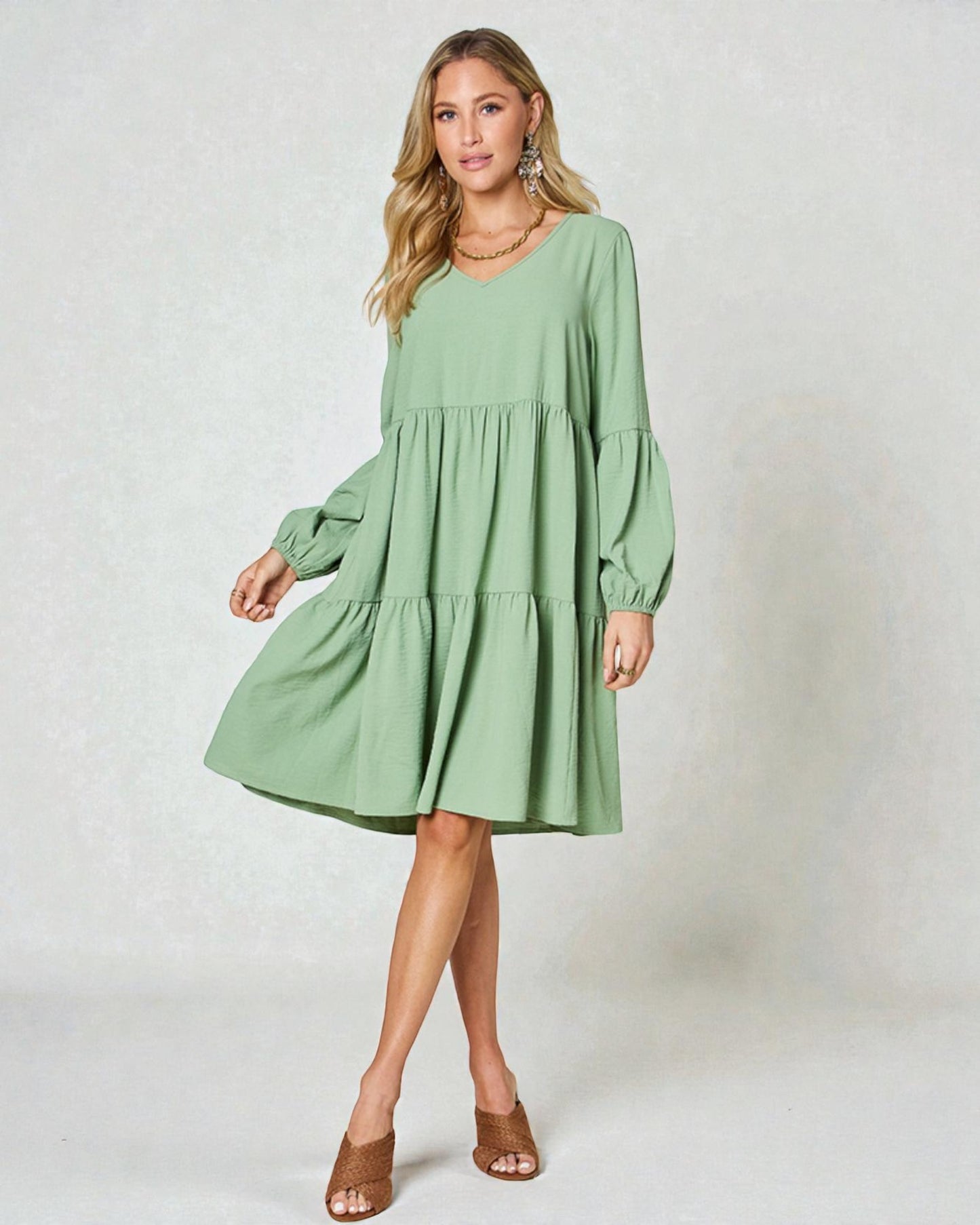 Woman wearing a green dress against a white background