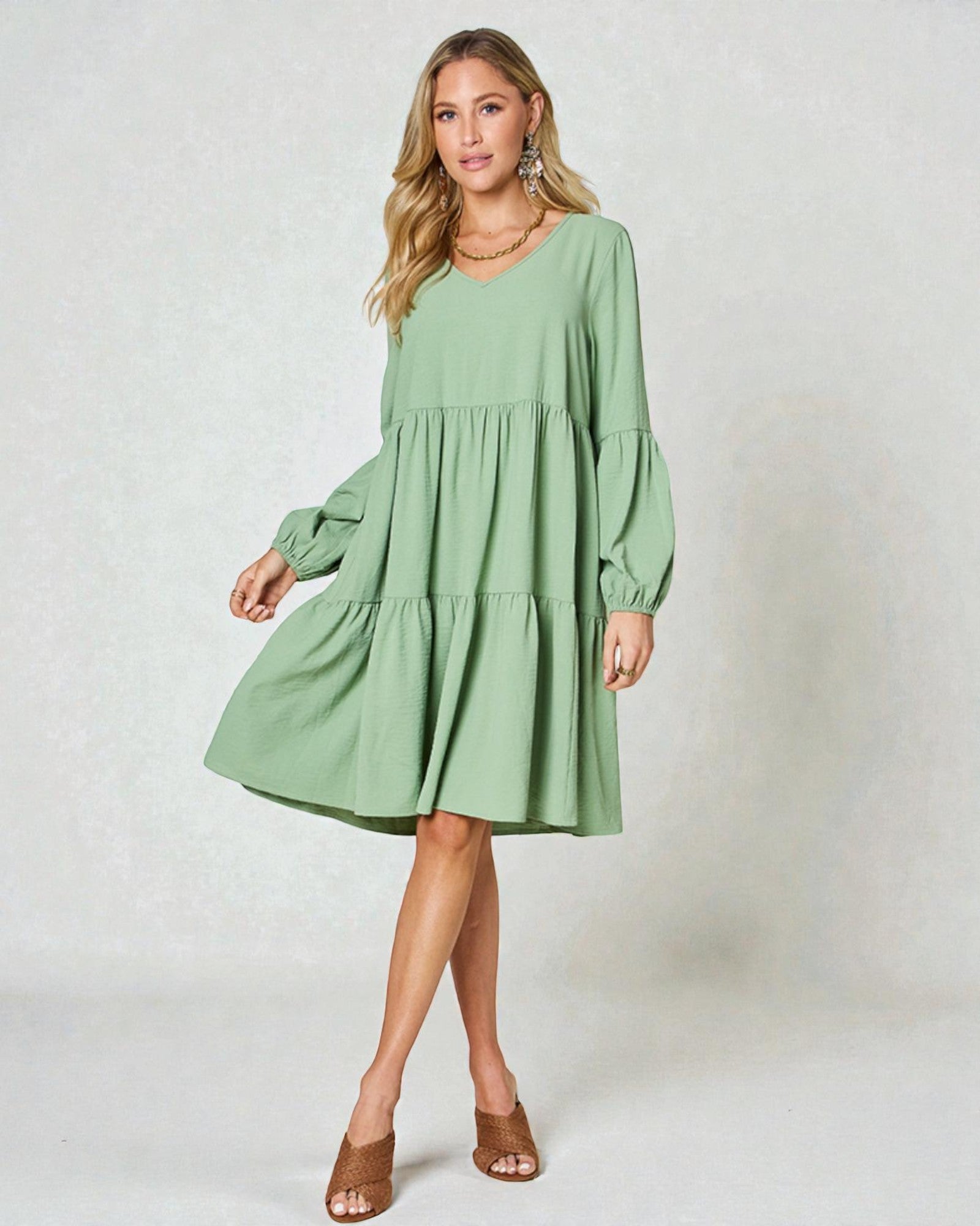 Woman wearing a green dress against a white background