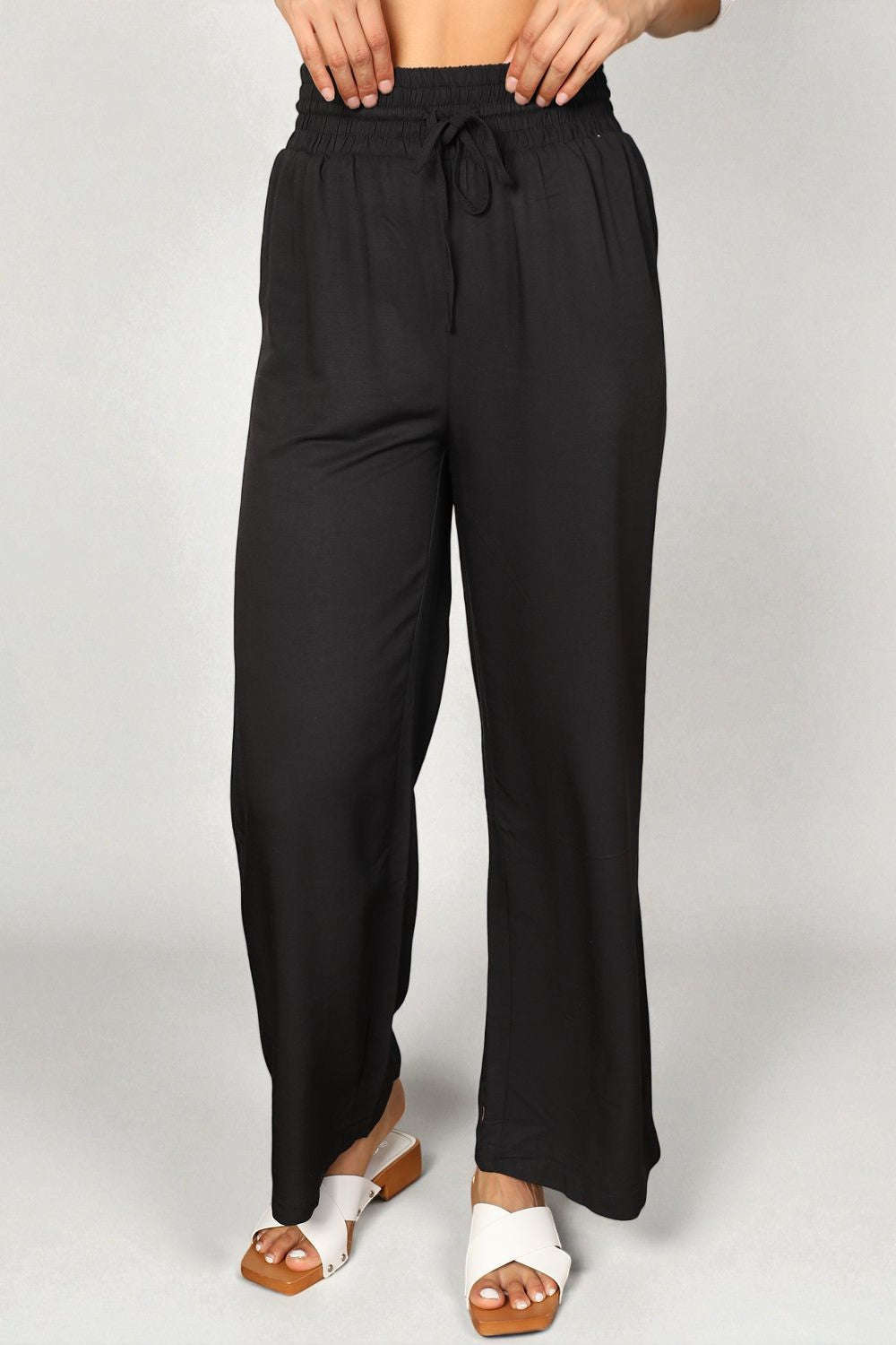Black wide-leg pants worn by a person on a plain background