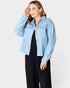 Woman wearing a light blue denim jacket on a white background