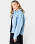 Woman wearing a light blue denim jacket on a white background