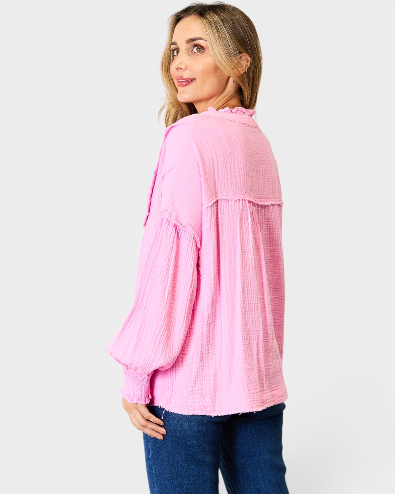Woman wearing a pink blouse with a white background