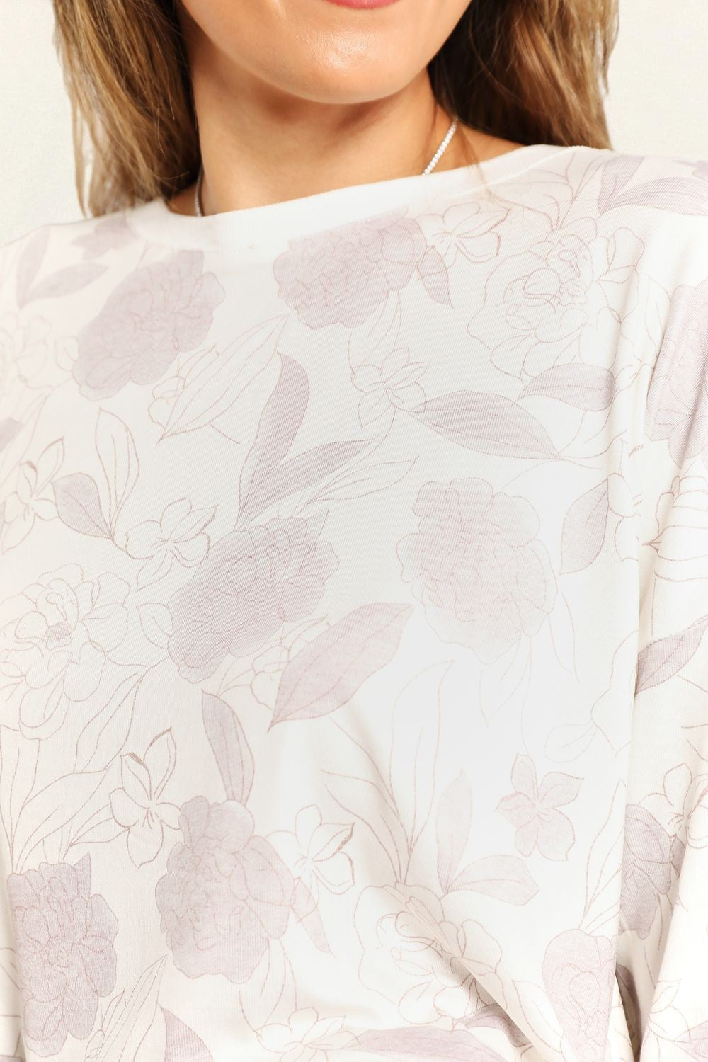 Close-up of a white blouse with floral pattern