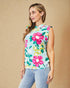 Woman wearing a sleeveless floral top with a beige background
