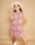 Woman wearing a floral dress and white hat on a beige background