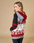 Woman wearing a red and black patterned sweater with a hood on a beige background