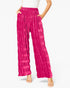 Bright pink wide-leg pants with a textured, crinkled fabric and an elastic waistband, shown on a model against a white background.