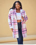 Woman wearing a pink plaid coat over a white top and blue jeans against a beige background